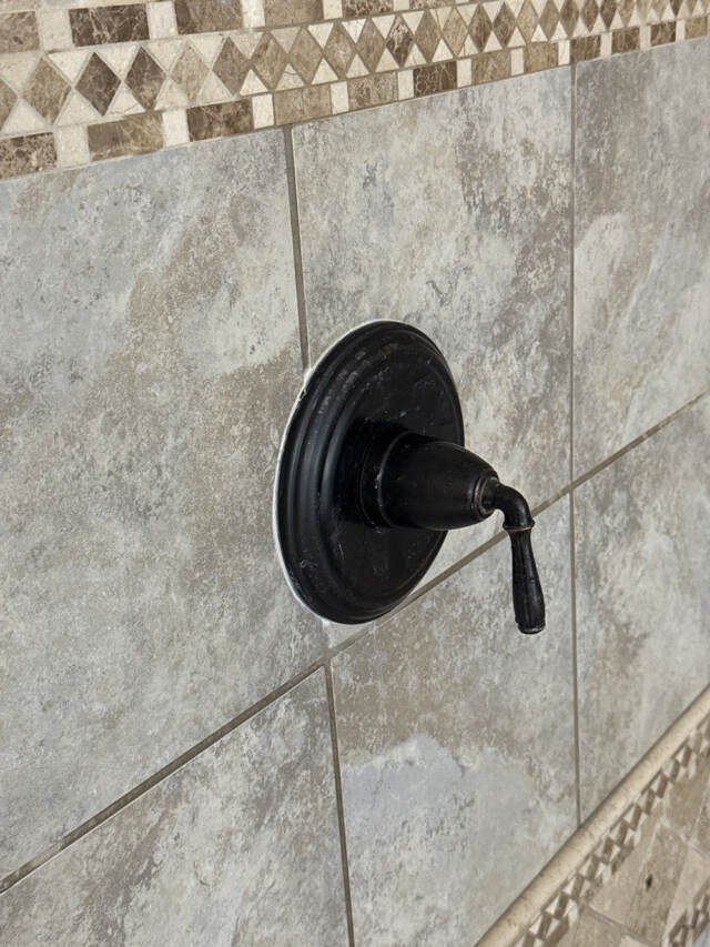 shower handle tightened and caulked