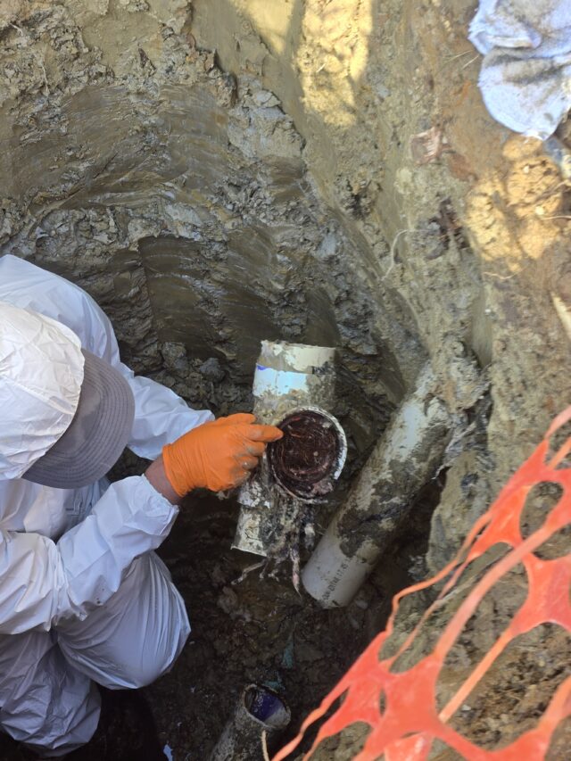 Working deep underground to repair and restore the main sewer line.