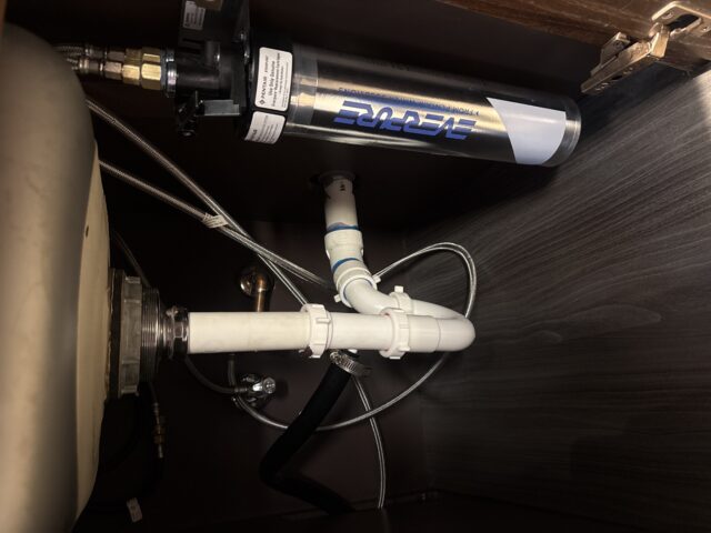 New outdoor refrigerator installation with proper water connection for reliable performance.