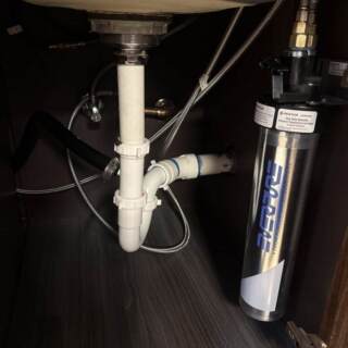 New outdoor refrigerator installation with proper water connection for reliable performance.