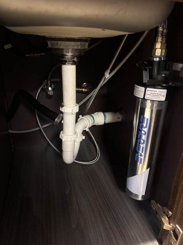 New outdoor refrigerator installation with proper water connection for reliable performance.