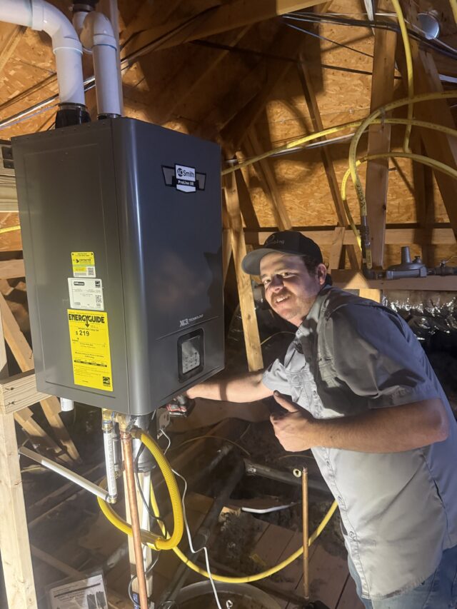 Completed attic installation of an AO Smith tankless water heater with a Leak Gopher flood control.
