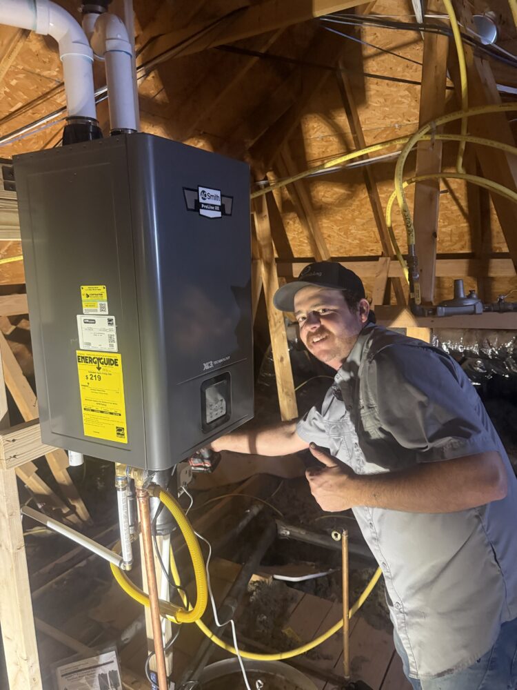 Completed attic installation of an AO Smith tankless water heater with a Leak Gopher flood control.