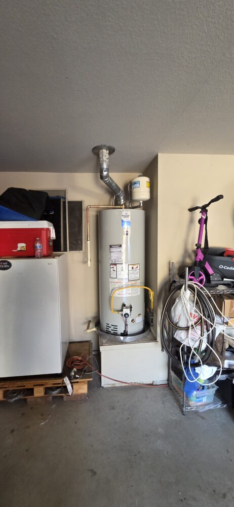 Completed garage installation of a 50-gallon Bradford White water heater with expansion tank.