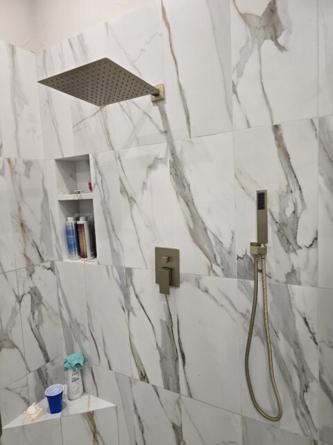Beautiful gold accent shower trim kit installed