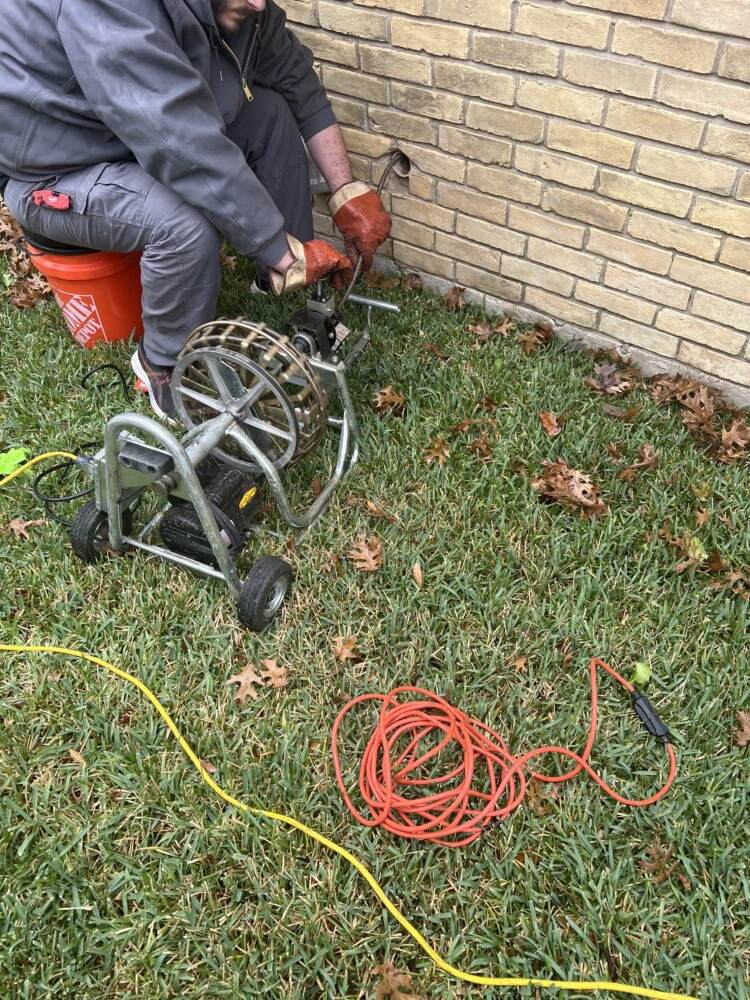 Plumber Nick hard at work clearing the clogged laundry drain