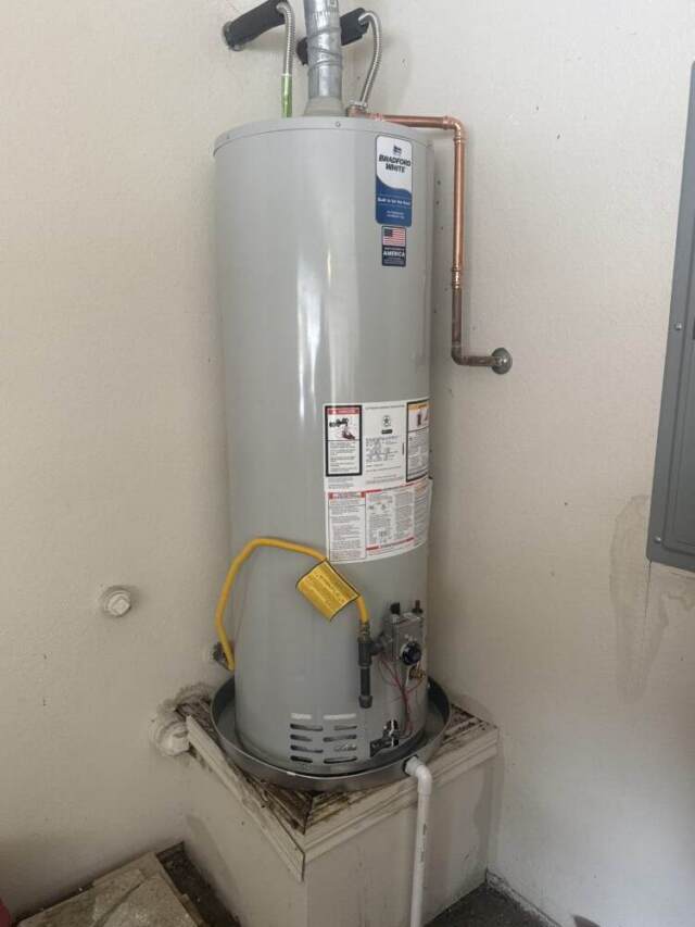 Completed installation of a 50-gallon Bradford White tank water heater in the garage