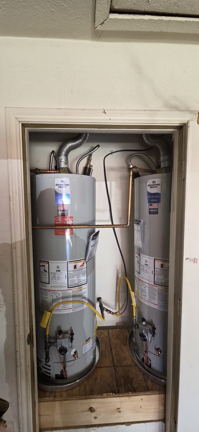 Completed installation of a 50-gallon Bradford White tank water heater in the garage, replacing an old unit to restore hot water.