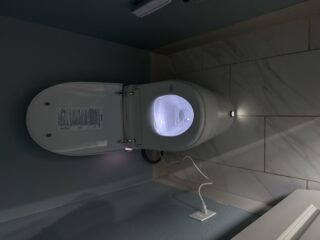 Modern Moen smart toilet with illuminated bowl and control panel installed in Frisco bathroom, showing LED lighting and advanced features.