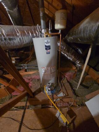 Bradford White gas water heater installed in attic with copper piping, expansion tank, and new shut-off valve