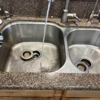 Running water in kitchen sink after drain clearing.