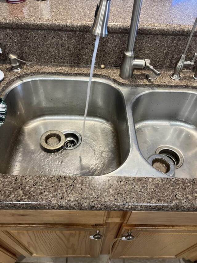 Running water in kitchen sink after drain clearing.