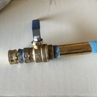 New brass ball valve with blue handle installed on copper water heater drain line for Frisco plumbing service