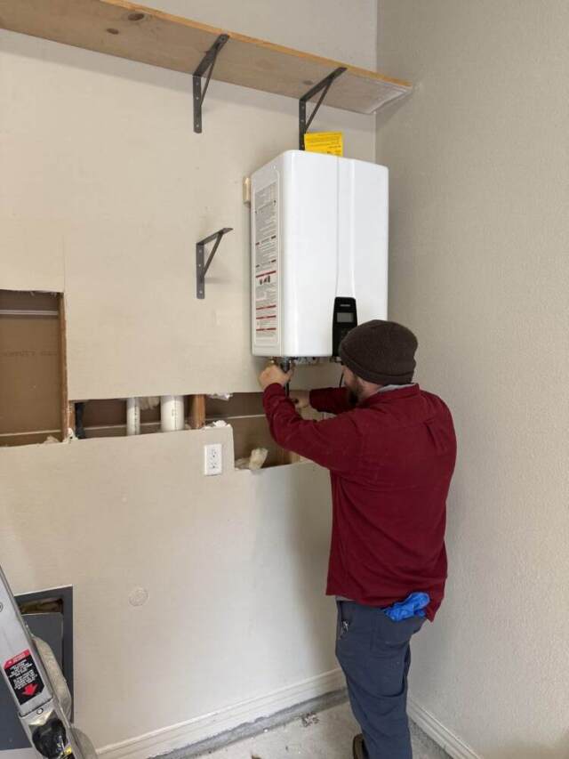Brandon installing Navien tankless water heater.
