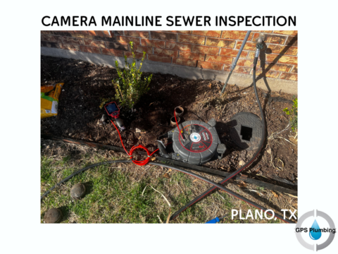 Camera inspection equipment with reel and monitor set up at a Plano sewer line access point near brick foundation