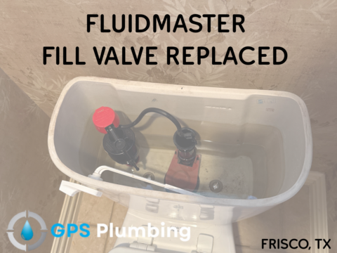 New Fluidmaster fill valve installed in toilet tank with red cap and gray inlet assembly visible inside white porcelain bowl.